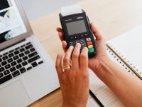 a person holding a device with keypad