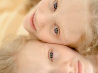 blonde haired woman lying on bed