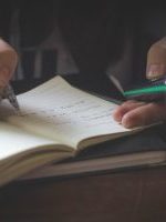 person writing while using phone