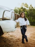 happy girl posing next to car