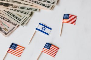 flags of usa and israel placed near dollar banknotes
