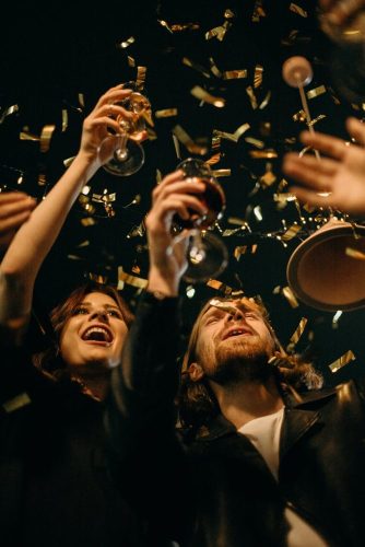 people holding wine glasses