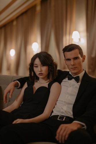couple wearing black suit and black dress